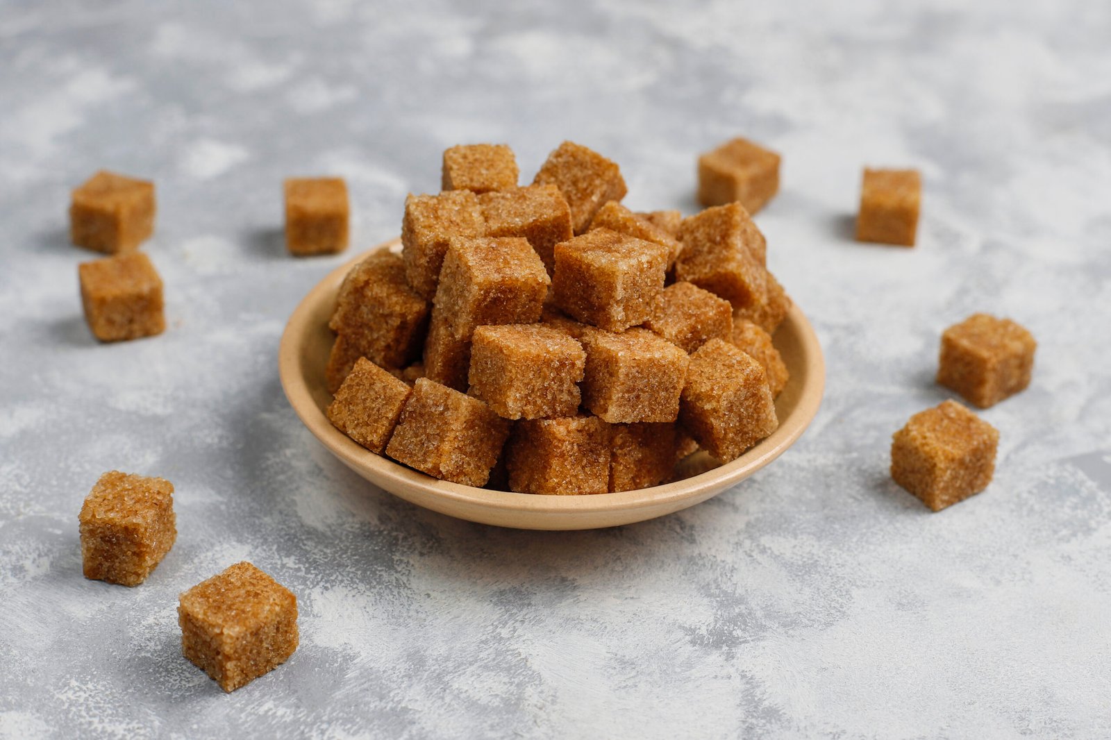 Brown sugar cubes on concrete background,top view